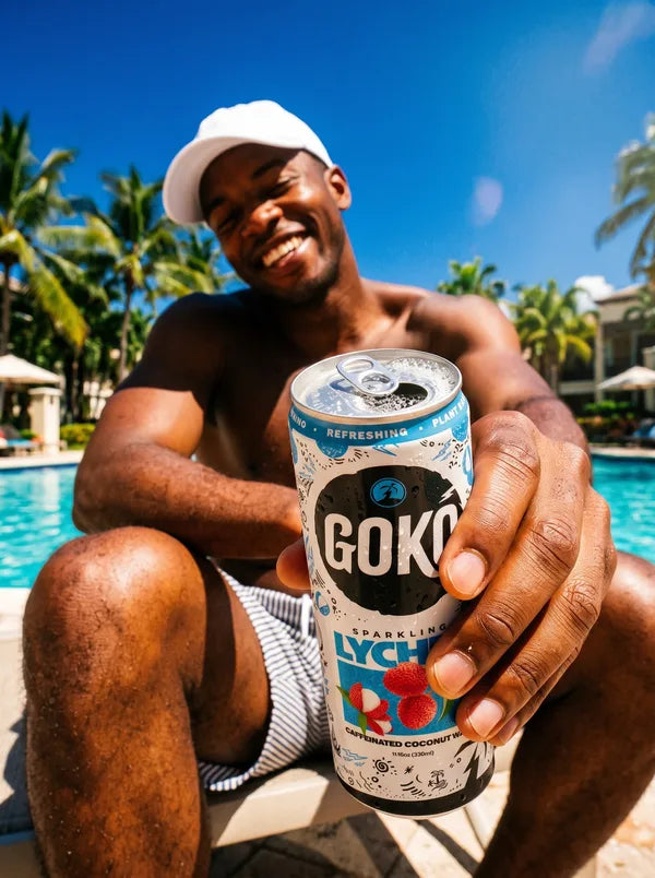 Man poolside holding a GOKO Lychee can